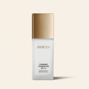 Meroda foundation bottle with gold cap on a beige background