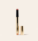 Hydrating Lip Tint in Honey Beige featuring a gold pen-style tube and a warm nude beige balm.
