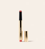 Hydrating Lip Tint in Peachy Rose featuring a sleek gold metallic pen with a detached cap on cream.