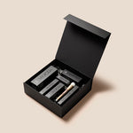 Open matte black Free Delivery gift box featuring a foundation brush and Meroda Cosmetics product boxes.