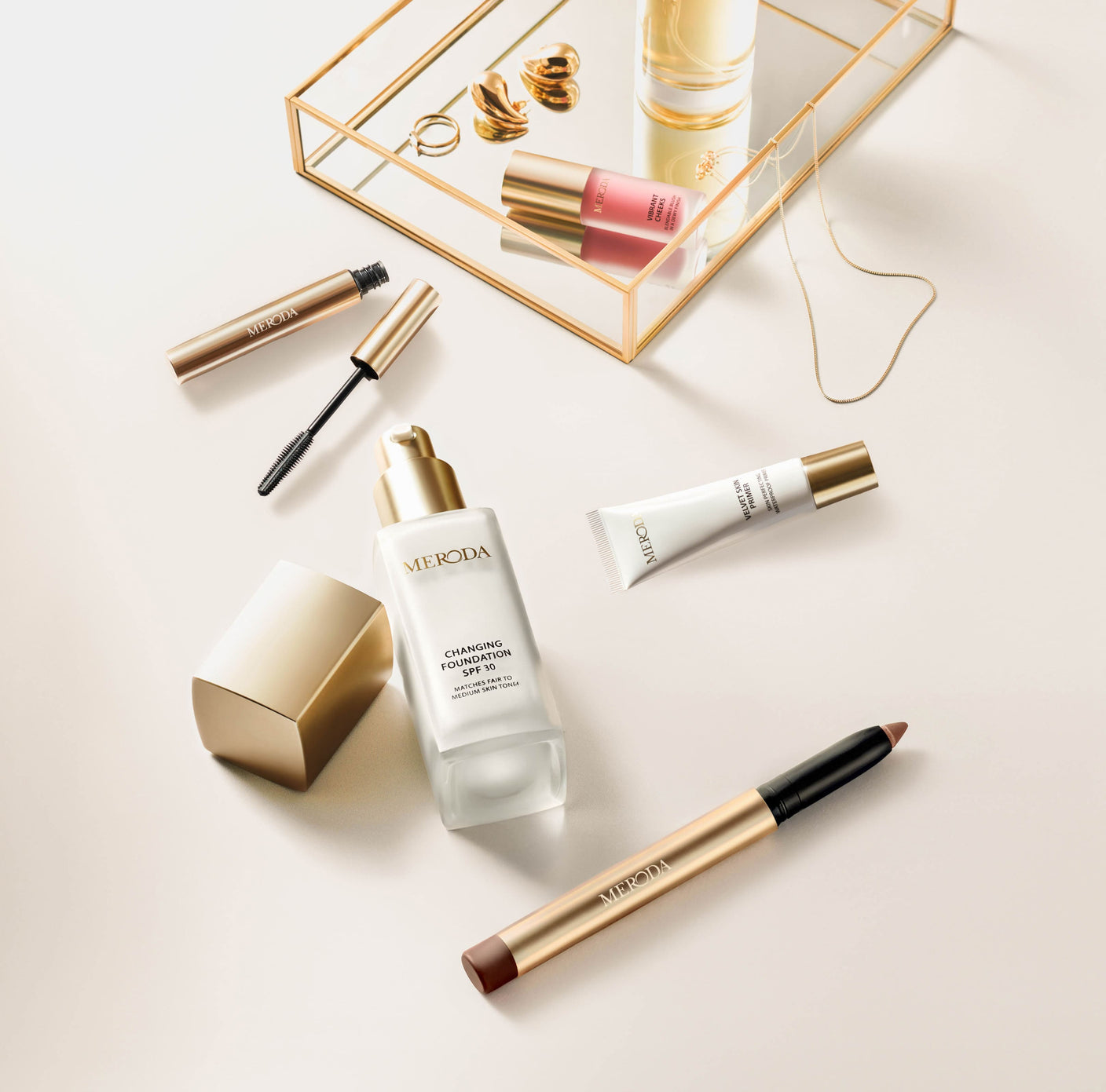 Essential Duo (+3 FREE GIFTS) featuring Changing Foundation, Eye Perfecting Shimmer Stick, Mini Gilded Lashes Mascara, Mini Velvet Skin Primer and Vibrant Cheek Blush on a light background
