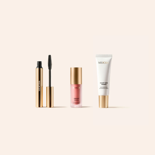 Meroda Mini's set featuring Gilded Lashes Mascara, Vibrant Cheeks Liquid Blush and Velvet Skin Primer in gold packaging.