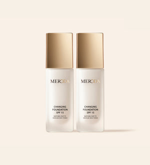 A bottle of 'Changing Foundation' by Meroda Cosmetics with a white and gold label.