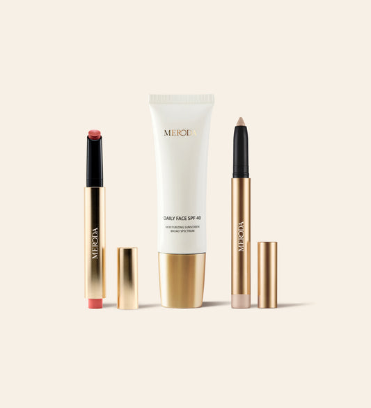 Sunkissed Trio featuring Daily Face SPF 40, Hydrating Lip Tint, and Eye Perfecting Shimmer Stick with gold finishes.