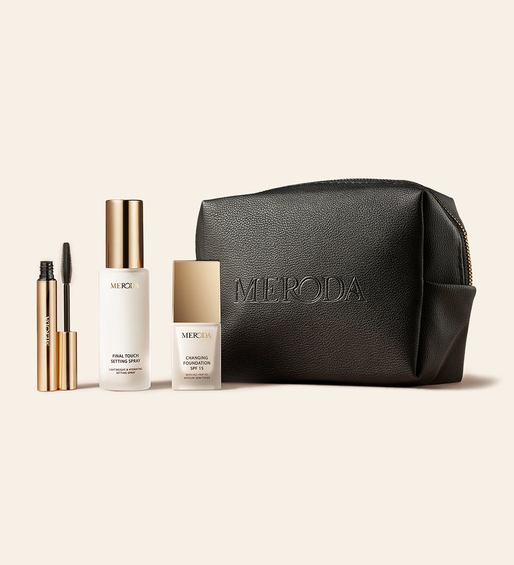 The Travel Kit featuring mini Changing Foundation, Final Touch Setting Spray, Gilded Lashes Mascara and a black travel bag