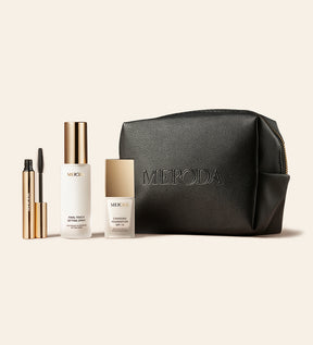 The Travel Kit featuring mini Changing Foundation, Final Touch Setting Spray, Gilded Lashes Mascara and a black travel bag
