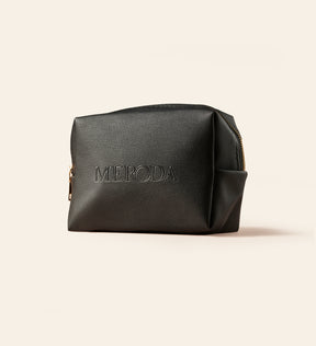 The Travel Bag in black featuring the embossed Meroda logo for keeping beauty essentials organised