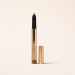 Eye Perfecting Shimmer Stick in Bronze, a shimmering cream eyeshadow in a gold metallic case on a light background.