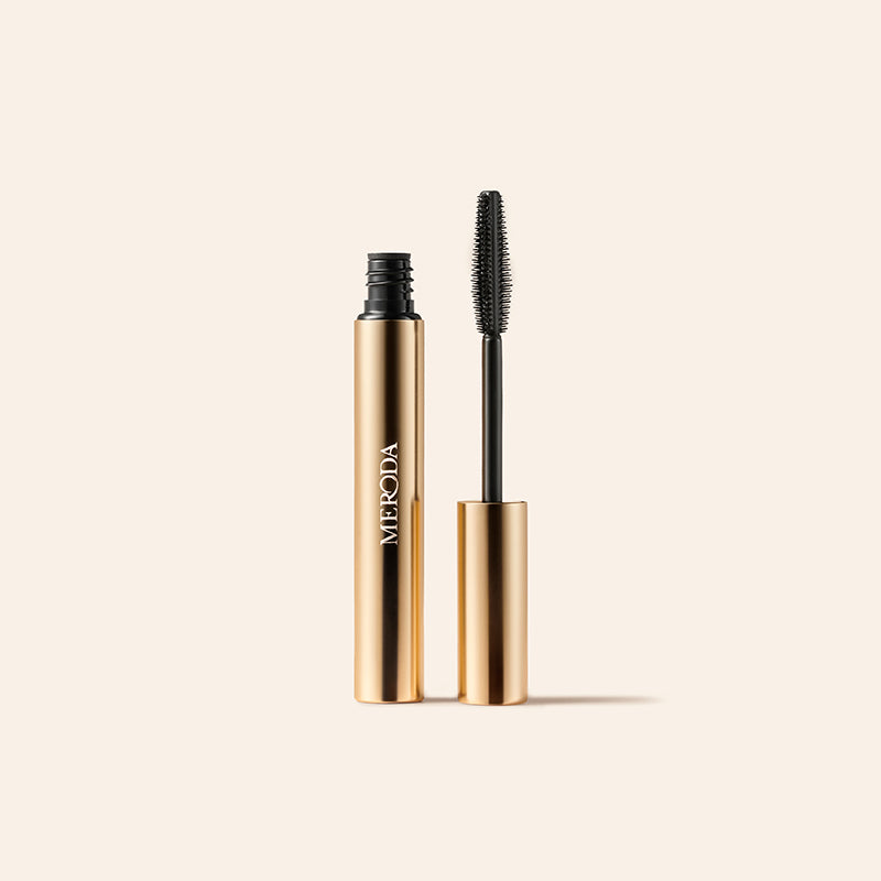 Mini Mascara in a gold tube with a black wand applicator for lengthening and volumising lashes.