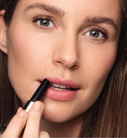Hydrating Lip Tint in Peachy Rose applied to lips for a fresh, buildable flush of sheer colour.