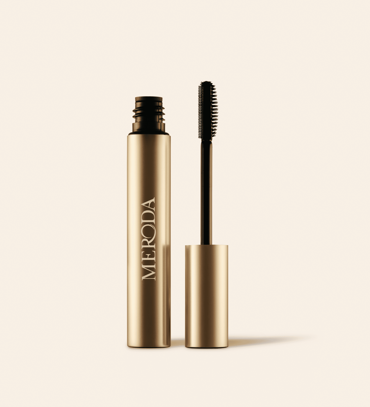 The Precision Brow Gel in an open gold tube featuring a silicone brush with dual-length bristles.