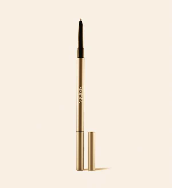 The Precision Brow Pencil in Blonde featuring a slim gold casing and an ultra-fine tip.