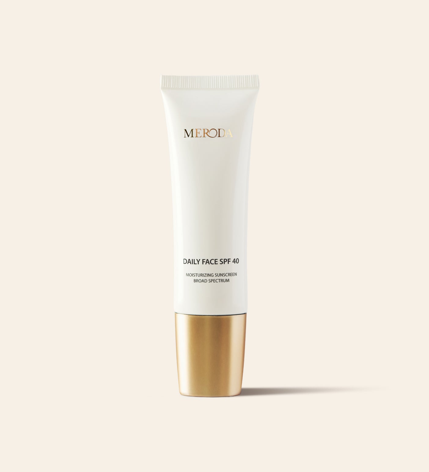 Daily Face SPF 40 moisturising sunscreen in a sleek white tube with a metallic gold cap.