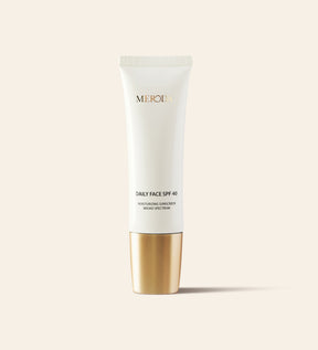 Daily Face SPF 40 moisturising sunscreen in a sleek white tube with a metallic gold cap.