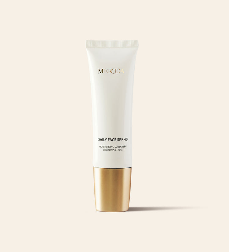 Daily Face SPF 40 moisturising sunscreen in a sleek white tube with a metallic gold cap.