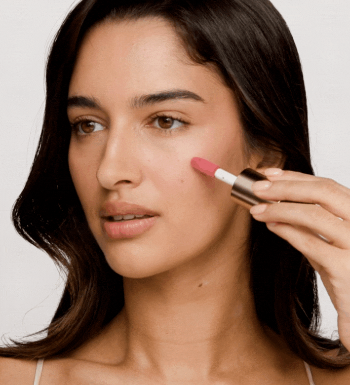 Vibrant Cheeks Liquid Blush in Pink Peony applied to a model's skin for a radiant, dewy finish.