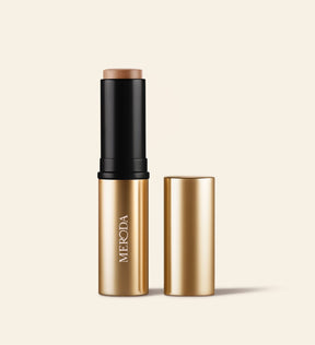 Soft Tan Bronzer in shade Light, featuring gold packaging and cap removed to show the creamy stick formula.