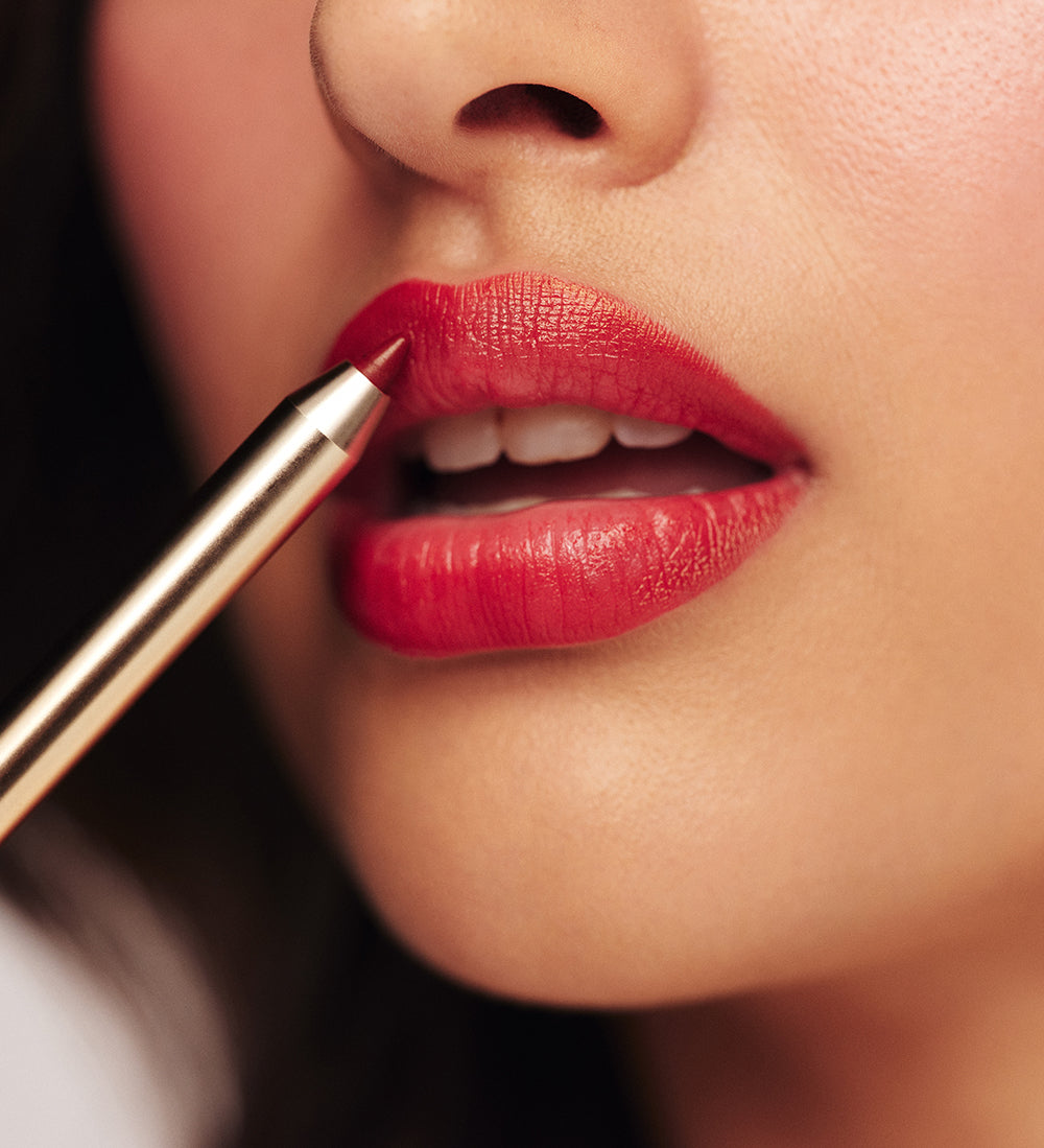 Model applying Signature Lip Pencil in Luscious Red from the Luscious Lips Set