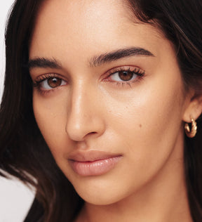 Close-up of model wearing Meroda Gilded Lashes Mascara showing long and defined lashes