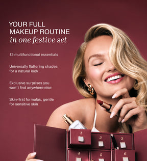 Smiling model holding a Meroda lipstick and opening the Advent Calendar filled with 12 beauty essentials.