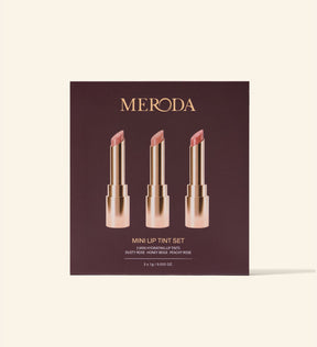 Mini Lip Tint Trio in packaging showing three hydrating lip tints in Dusty Rose, Honey Beige, and Peachy Rose.