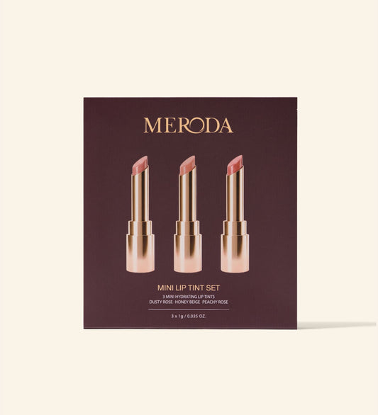 Mini Lip Tint Trio in packaging showing three hydrating lip tints in Dusty Rose, Honey Beige, and Peachy Rose.
