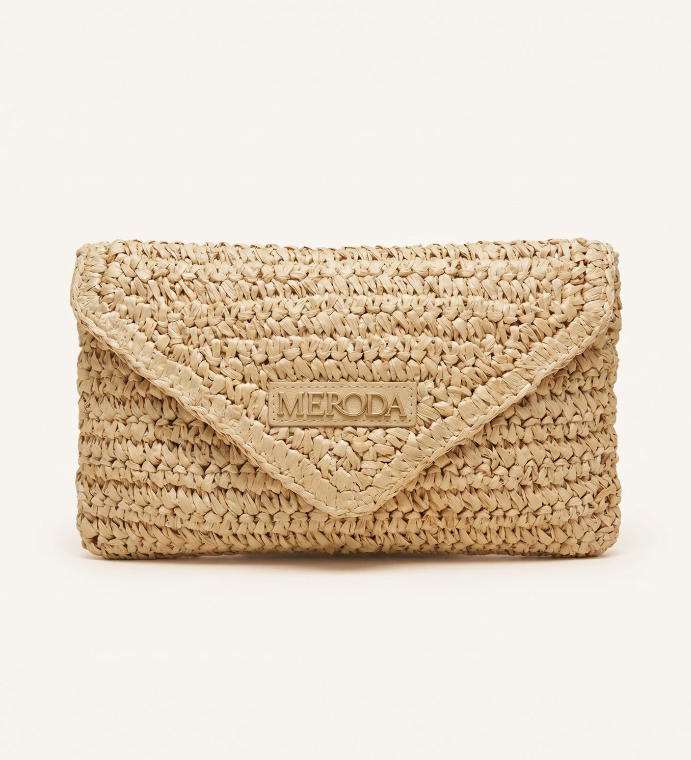 Natural woven paper straw Summer Travel Clutch with a triangular flap and central Meroda logo plate.