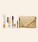 Summer Travel Icons set featuring SPF 40, foundation, lip tint and mascara with a beige woven raffia clutch.