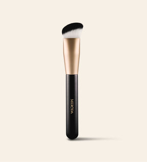 Meroda Cosmetics The Essential Brush featuring a unique triangular shape and dense bristles for precise application and seamless blending