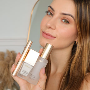 Meroda Cosmetics Travel Kit featuring mini Changing Foundation, Final Touch Setting Spray and Gilded Lashes Mascara held by a woman